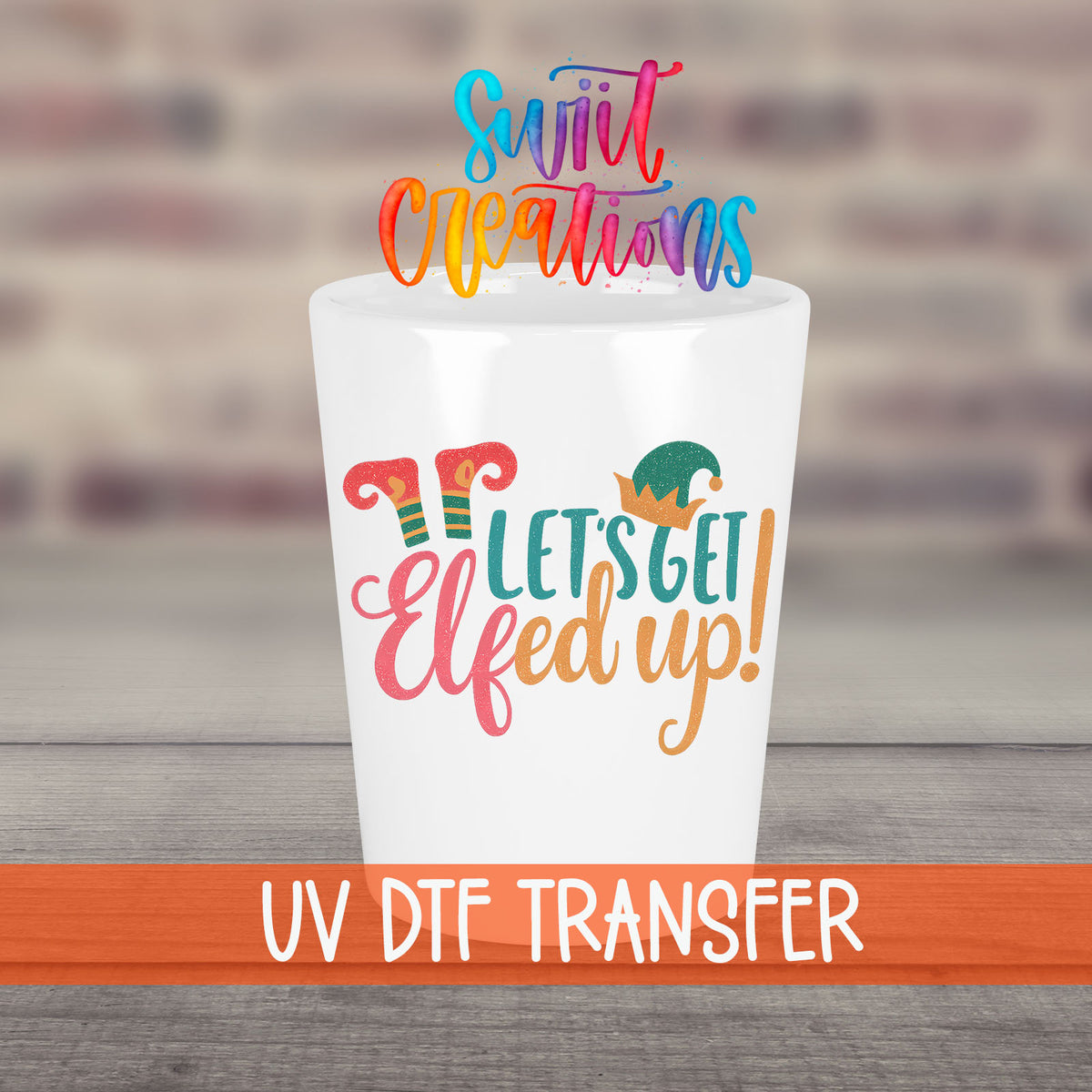 Let's Get Elfed Up UV DTF transfer on a white shot glass in front of a brick wall