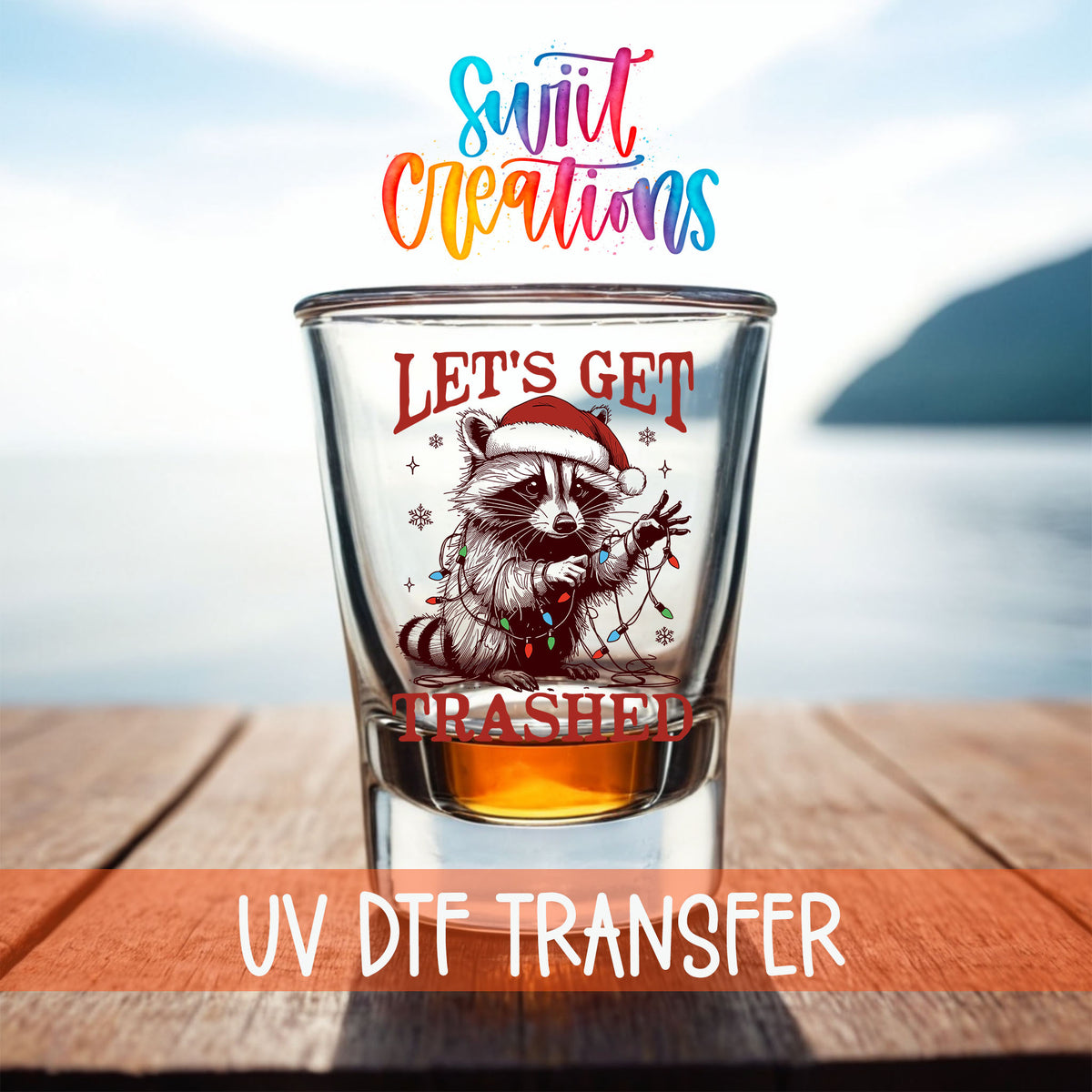 Let's Get Trashed Christmas shot glass UV DTF transfer on a filled shot glass on a dock by the water