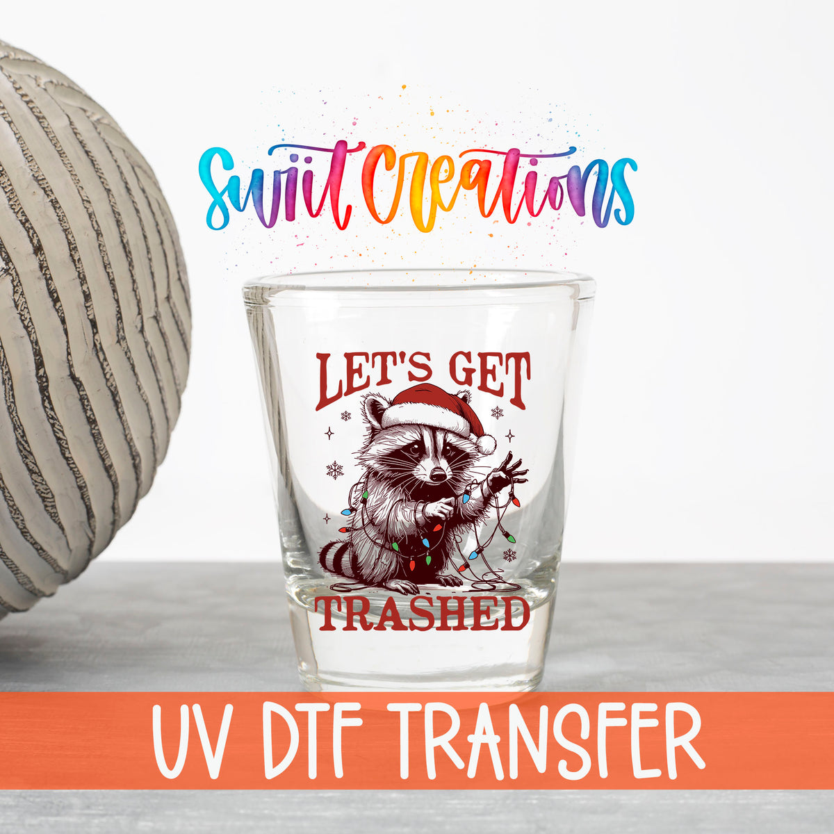 Let's Get Trashed Christmas UV DTF transfer on a clear shot glass with the Swiit Creations logo and UV DTF Transfer banner