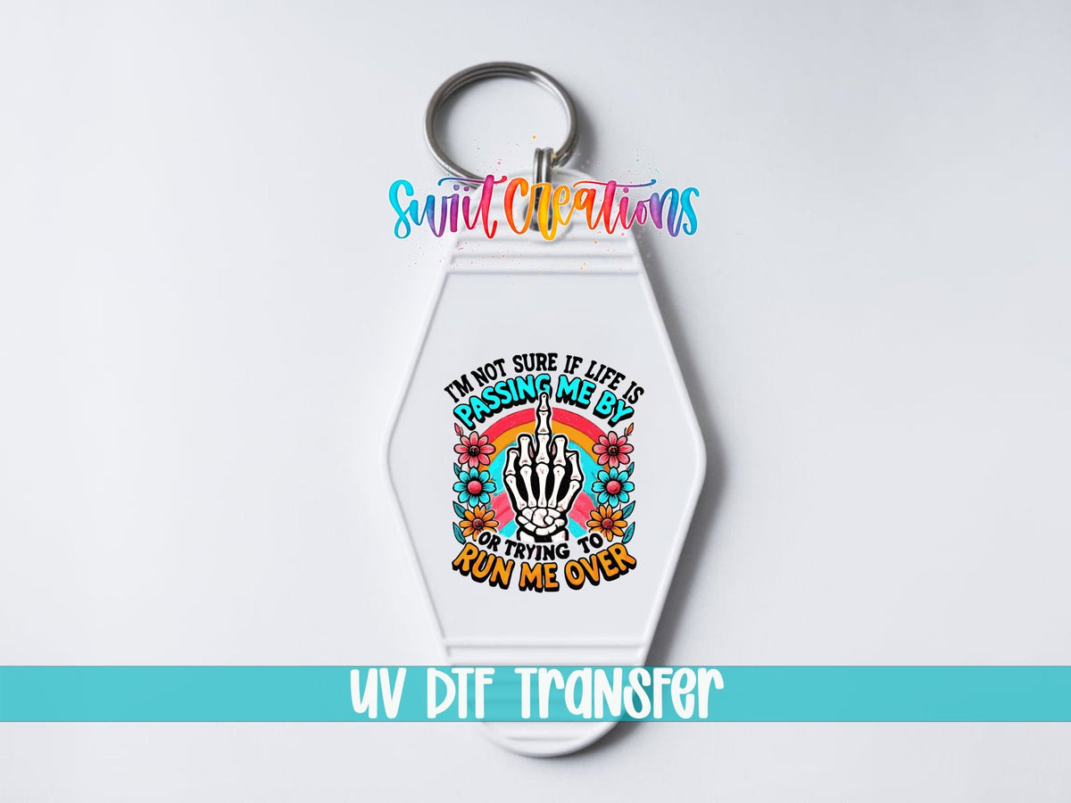 Passing Me By or Running Me Over UV DTF transfer on a white motel keychain on a white background