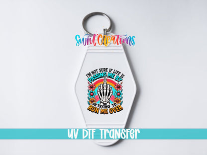 Passing Me By or Running Me Over UV DTF transfer on a white motel keychain on a white background