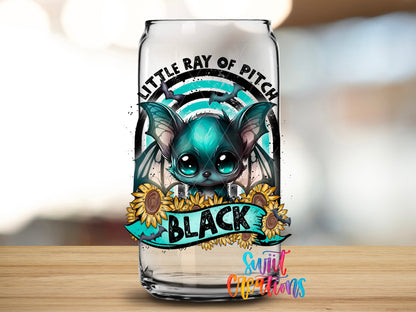 Close-up of the Little Ray of Pitch Black UV DTF transfer on a clear glass can