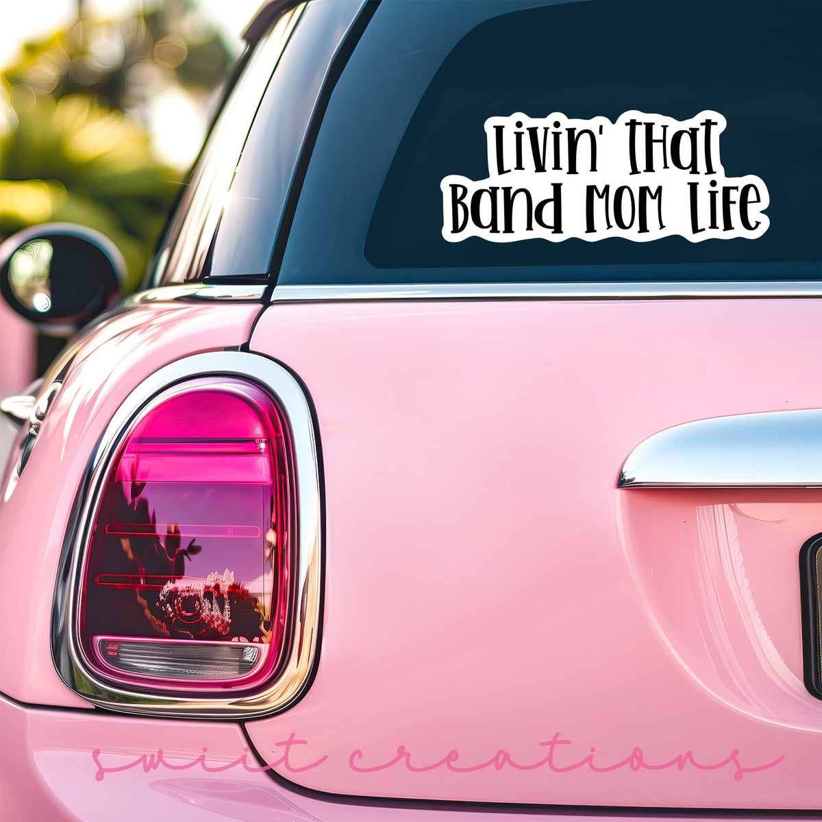 Black Band Mom Life sticker on the back window of a pink car