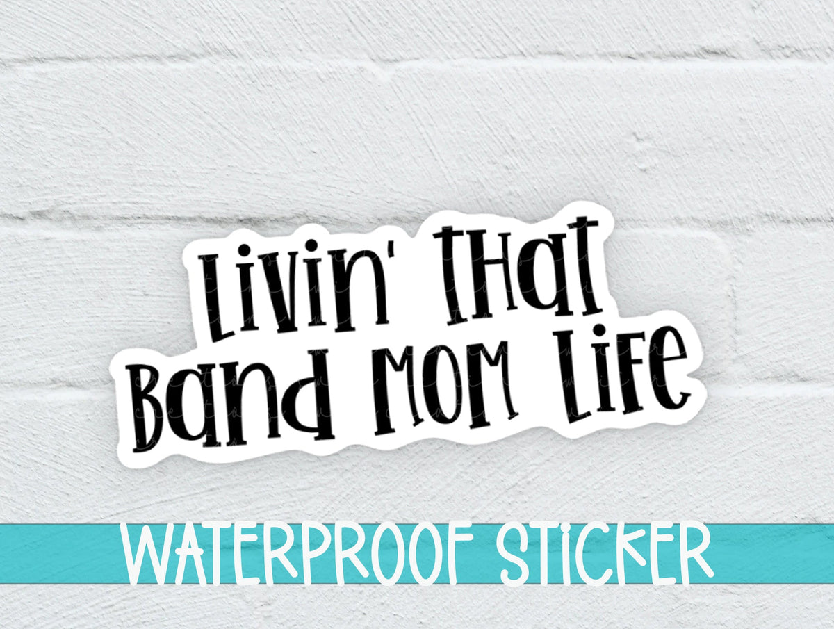 Black Band Mom Life sticker on a white brick background with a waterproof sticker banner