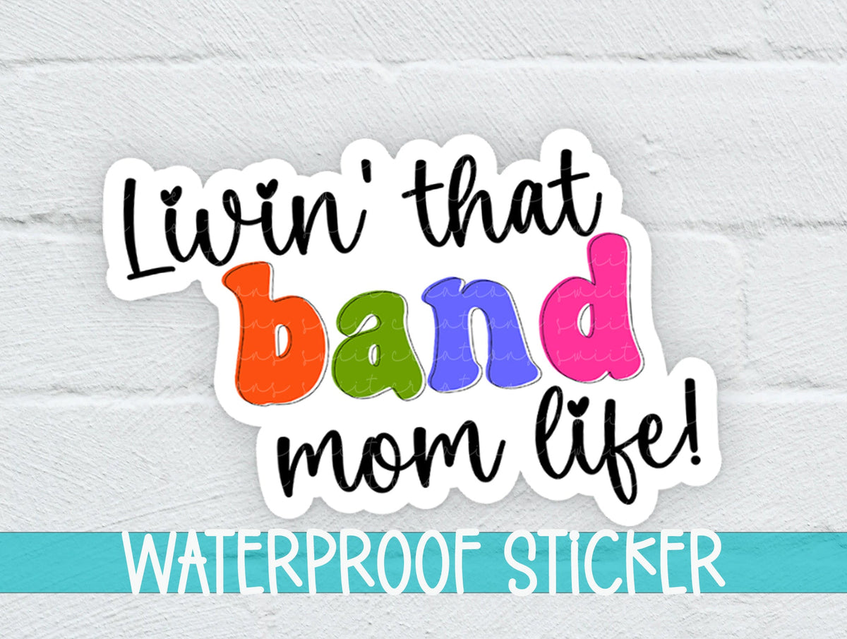 Rainbow Band Mom Life sticker on a white brick background with a waterproof sticker banner