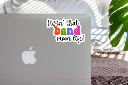 Rainbow Band Mom Life sticker on the lid of a silver laptop