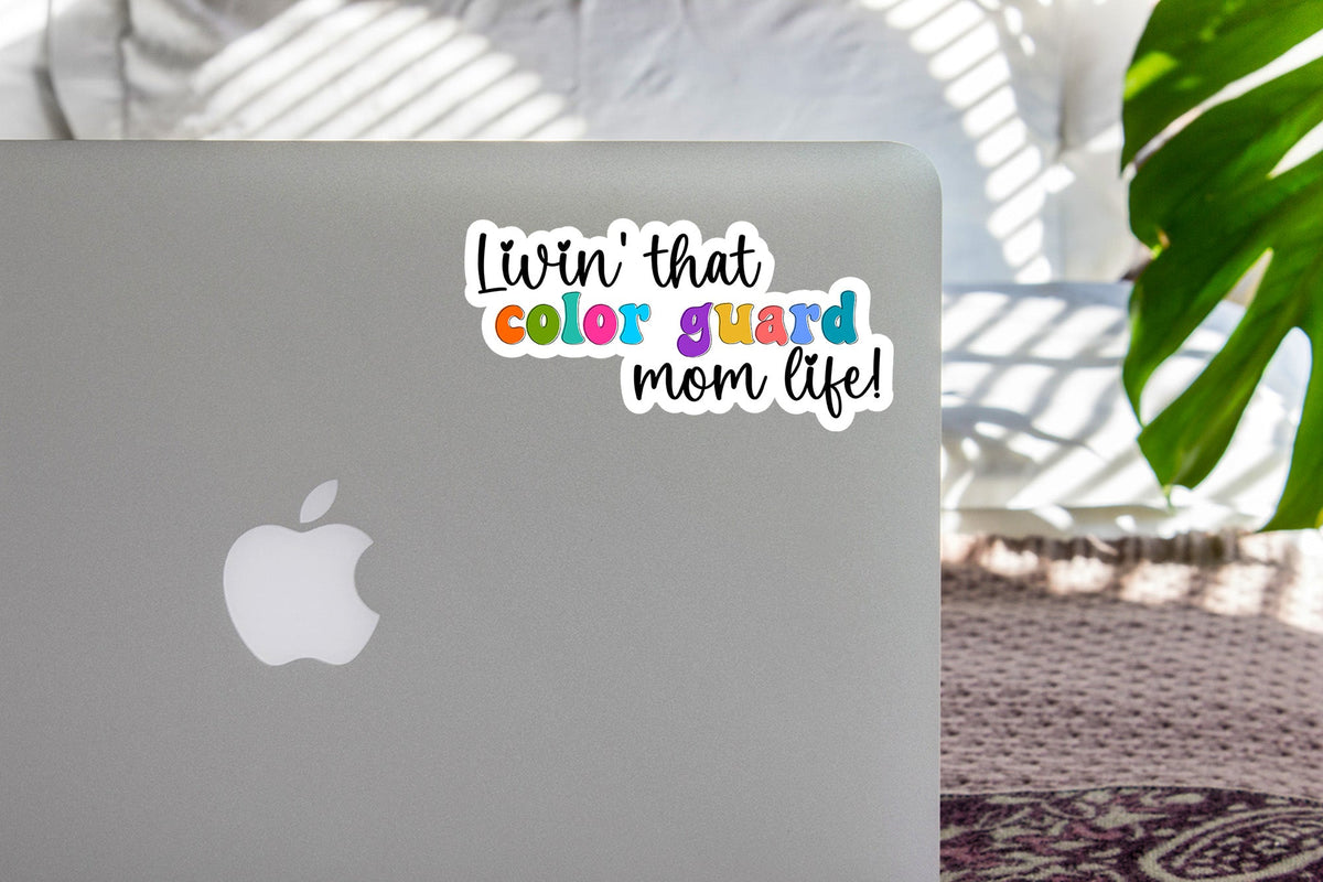 Rainbow Color Guard Mom Life sticker on the lid of a silver laptop