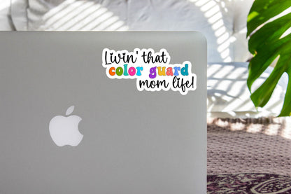 Rainbow Color Guard Mom Life sticker on the lid of a silver laptop