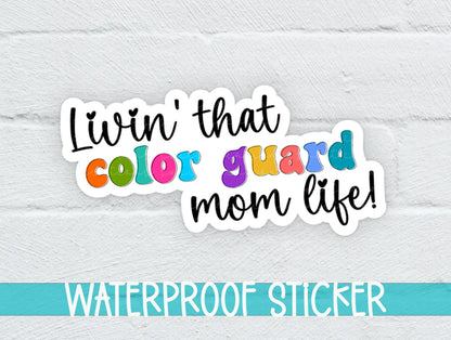 Rainbow Color Guard Mom Life sticker on a white brick background with a waterproof sticker banner