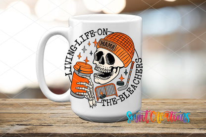 Living Life on the Bleachers skeleton in an orange mama cap UV DTF transfer on a white ceramic coffee mug