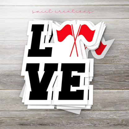 Stack of Red Love Color Guard glossy stickers on a gray wood table