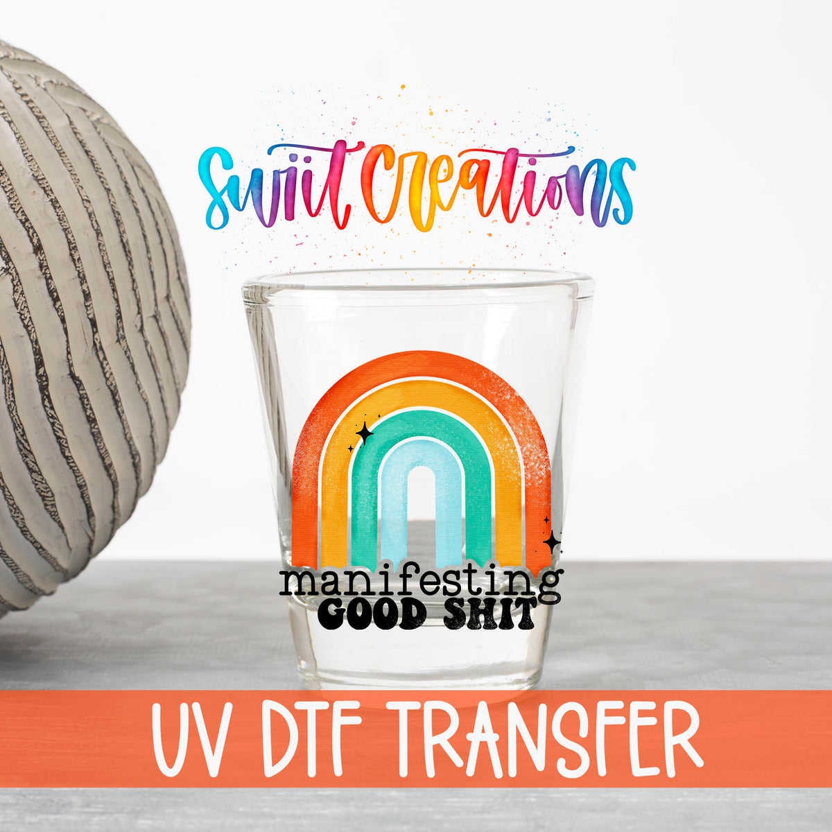 Manifesting Good Sh*t UV DTF transfer on a clear shot glass with the Swiit Creations logo and UV DTF Transfer banner