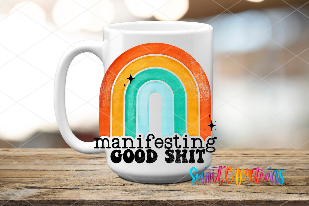 Manifesting Good Sh*t UV DTF transfer on a white ceramic coffee mug