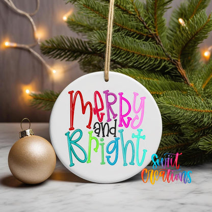 Merry and Bright ornament UV DTF transfer on a hanging ornament with pine branches and a gold bauble