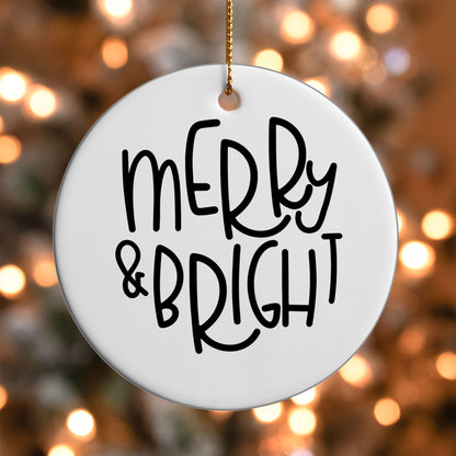 Merry and Bright ornament UV DTF transfer on a round white ornament with a bokeh light background