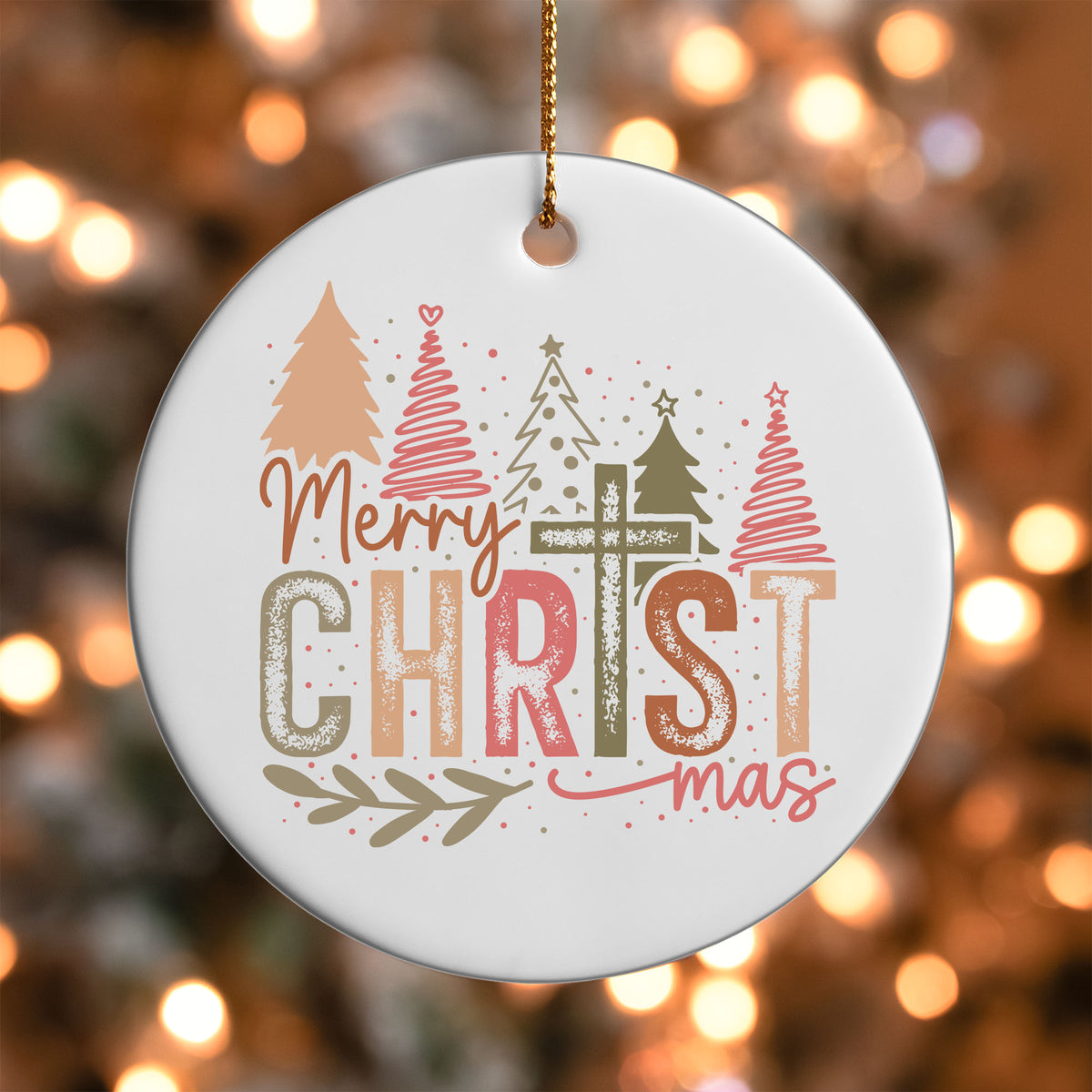Merry Christmas Cross ornament UV DTF transfer on a round white ornament with a bokeh light background