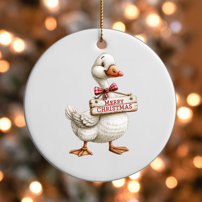 Merry Christmas Goose ornament UV DTF transfer on a round white ornament with a bokeh light background
