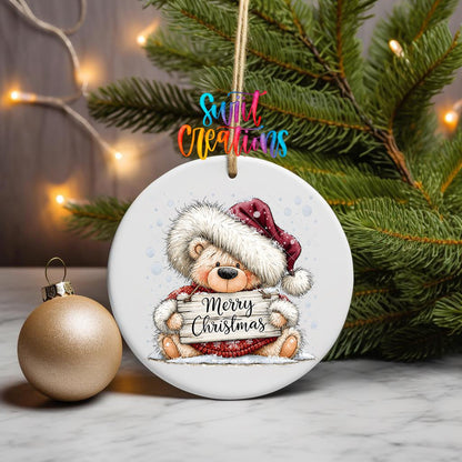 Merry Christmas Teddy Bear ornament UV DTF transfer on a hanging ornament with pine branches and a gold bauble