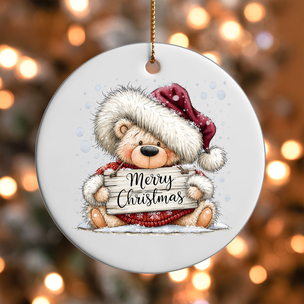 Merry Christmas Teddy Bear ornament UV DTF transfer on a round white ornament with a bokeh light background