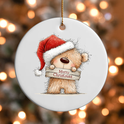 Merry Christmas Teddy Bear ornament UV DTF transfer on a round white ornament with a bokeh light background
