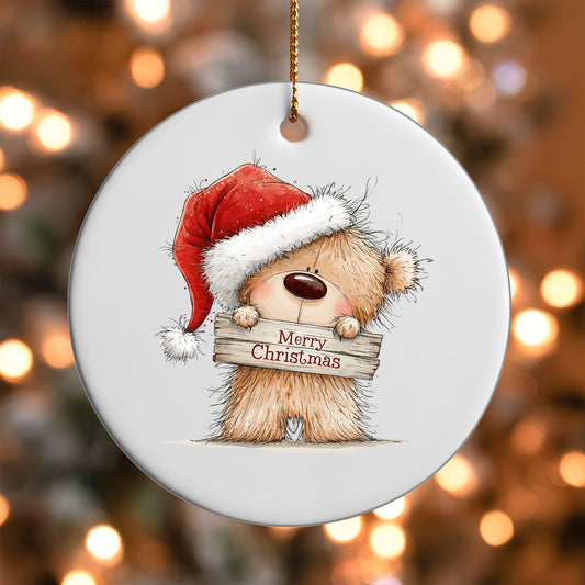 Merry Christmas Teddy Bear ornament UV DTF transfer on a round white ornament with a bokeh light background