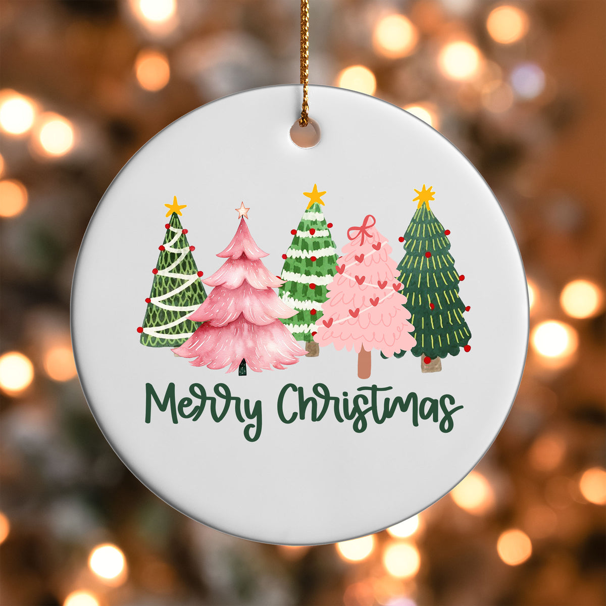 Merry Christmas Trees ornament UV DTF transfer on a round white ornament with a bokeh light background