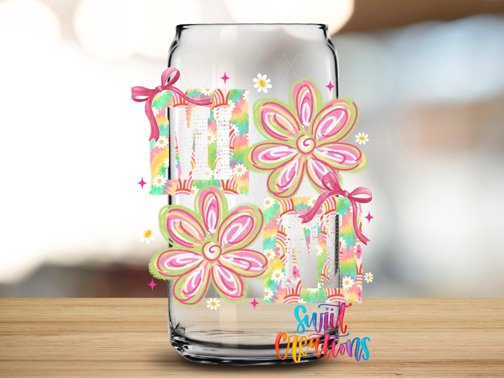 Mini Tie Dye Flowers UV DTF transfer applied to a clear glass can from Swiit Creations