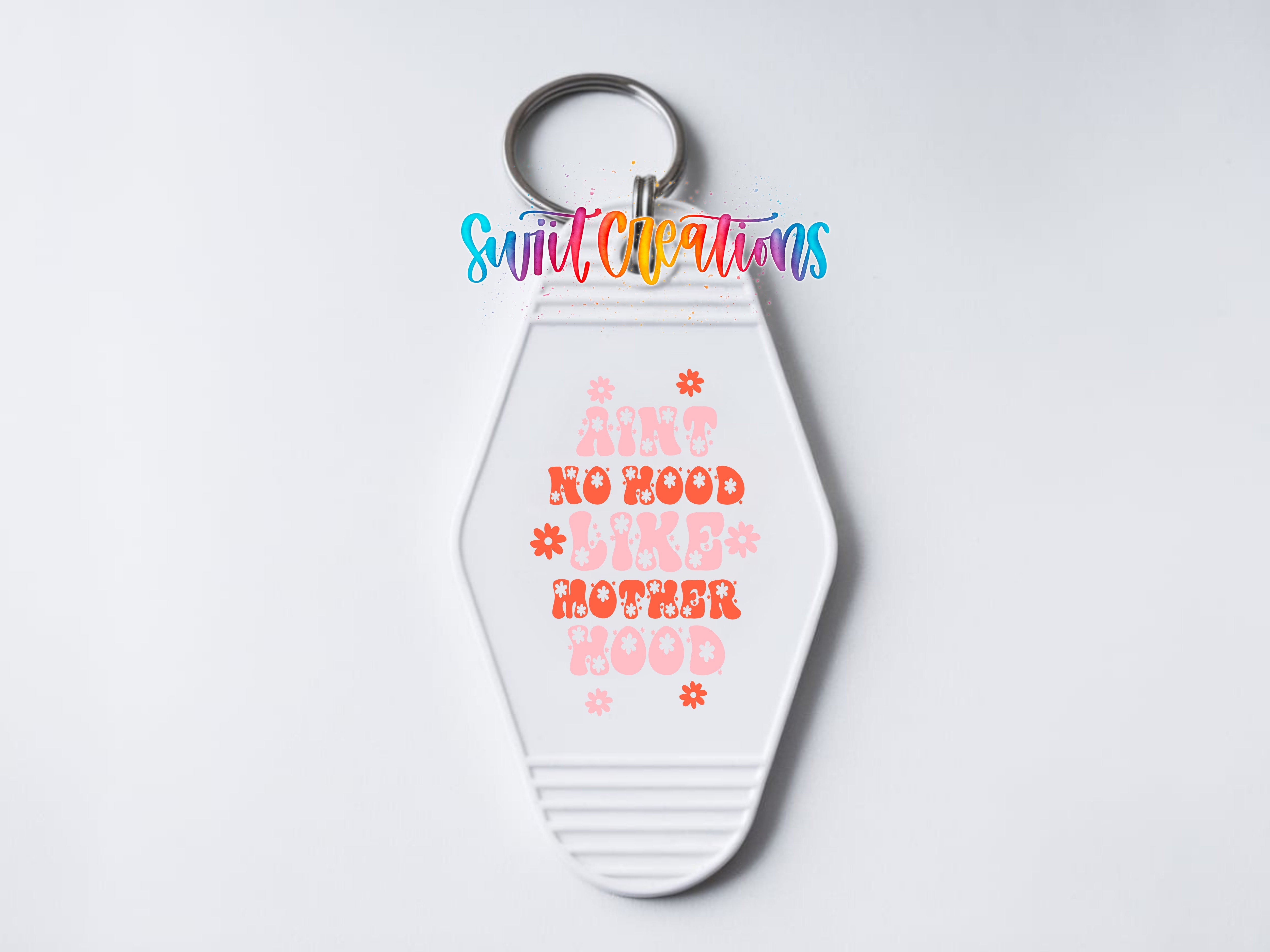 Ain’t No Hood Like Motherhood UV DTF transfer on a white motel keychain close-up mockup