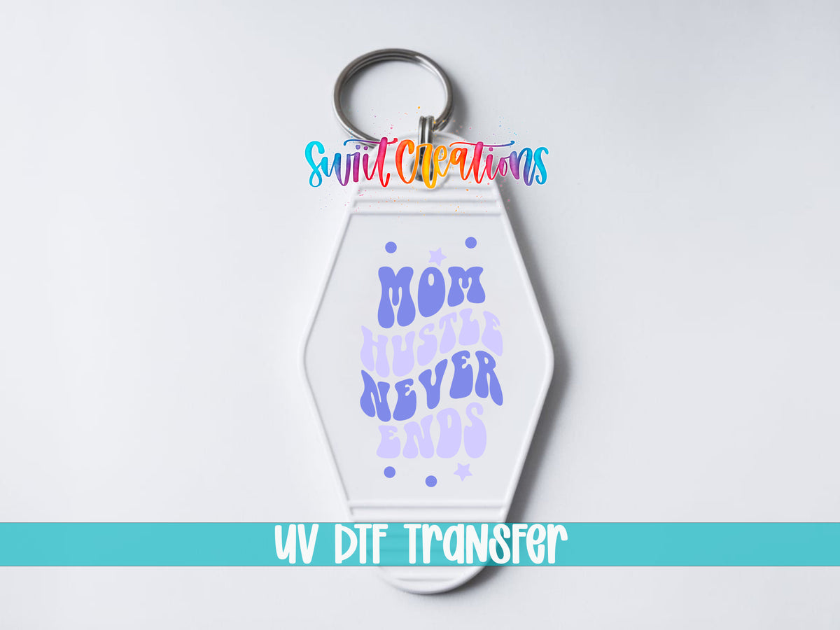 Mom Hustle Never Ends motel keychain UV DTF transfer close-up mockup by Swiit Creations