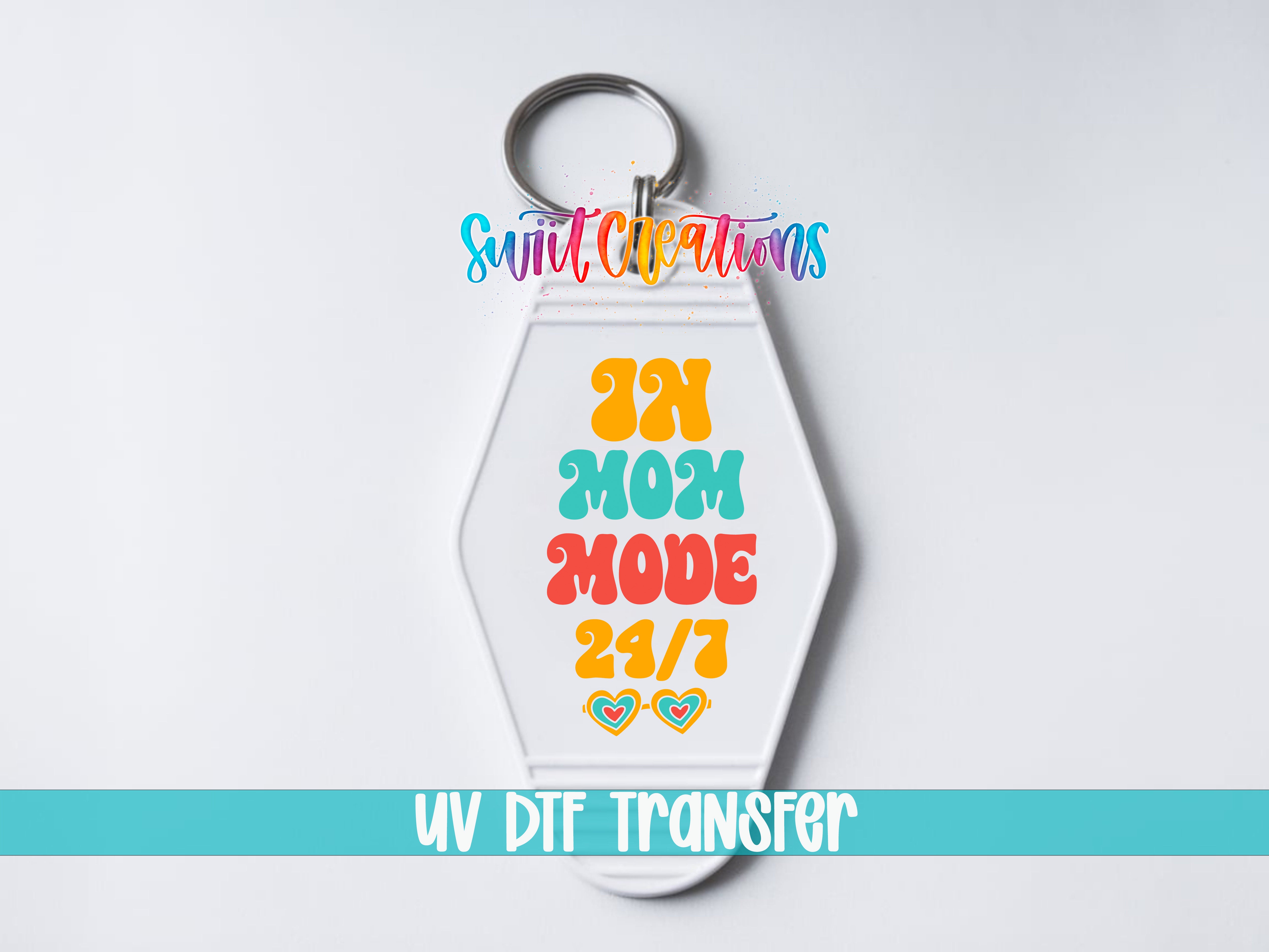 In Mom Mode 24/7 motel keychain UV DTF transfer close-up mockup by Swiit Creations