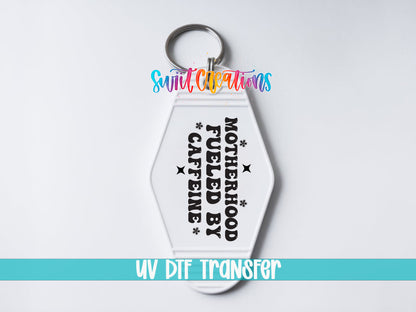 Motherhood Fueled by Caffeine motel keychain UV DTF transfer close-up mockup by Swiit Creations