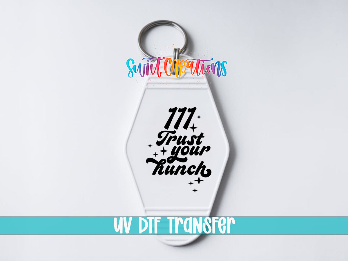 111 Trust Your Hunch motel keychain UV DTF transfer close-up mockup by Swiit Creations