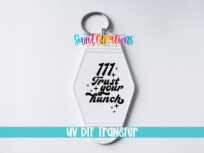 111 Trust Your Hunch motel keychain UV DTF transfer close-up mockup by Swiit Creations