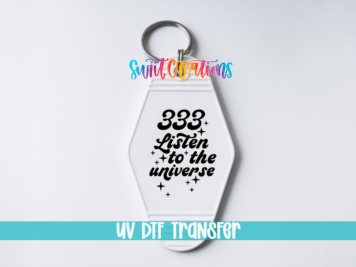 333 Listen to the Universe motel keychain UV DTF transfer close-up mockup by Swiit Creations