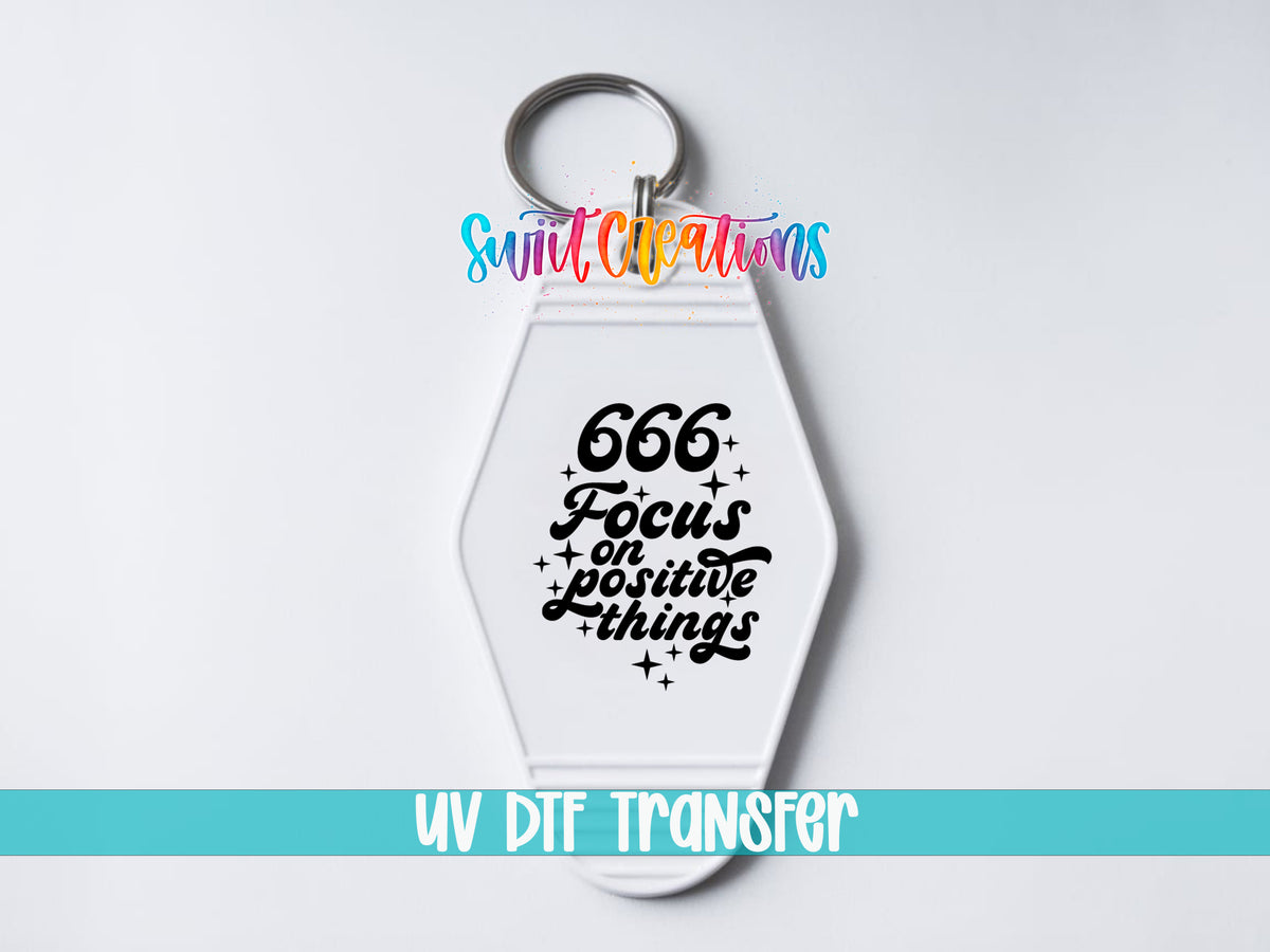 666 Focus on Positive Things motel keychain UV DTF transfer close-up mockup by Swiit Creations