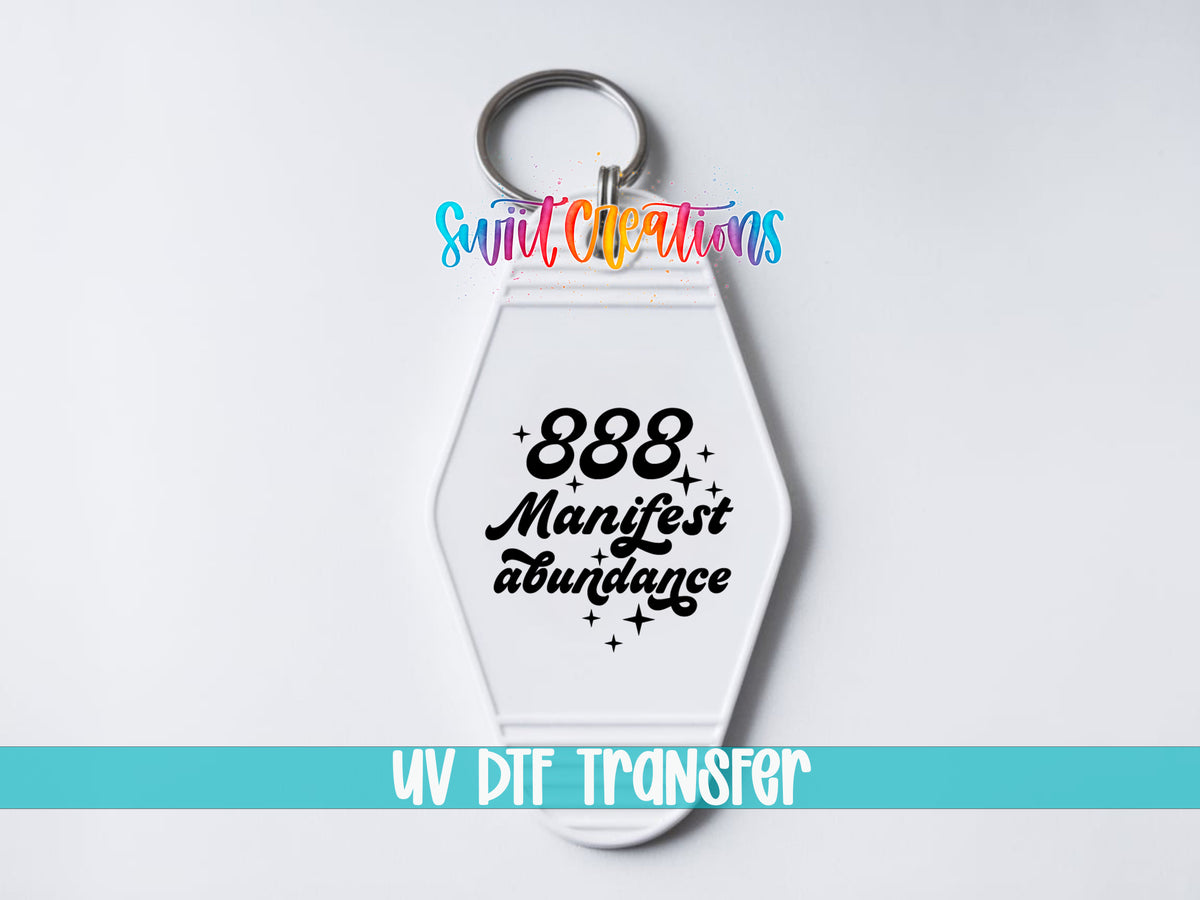 888 Manifest Abundance motel keychain UV DTF transfer close-up mockup by Swiit Creations