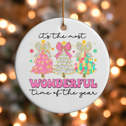 Most Wonderful Time of the Year ornament UV DTF transfer on a round white ornament with a bokeh light background