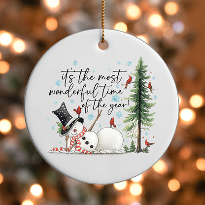 Most Wonderful Time of the Year Snowman ornament UV DTF transfer on a round white ornament with a bokeh light background