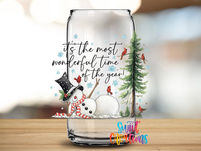 Close-up of the It's the Most Wonderful Time of the Year snowman and cardinals UV DTF transfer on a clear glass can