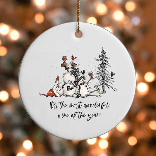 Most Wonderful Wine of the Year ornament UV DTF transfer on a round white ornament with a bokeh light background