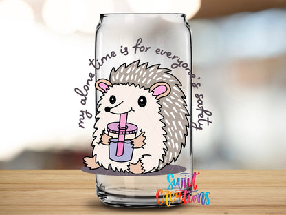 Close-up of the My Alone Time Is for Everyone's Safety UV DTF transfer on a clear glass can
