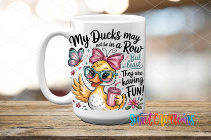 My Ducks May Not Be in a Row duck with a pink drink UV DTF transfer on a white ceramic coffee mug