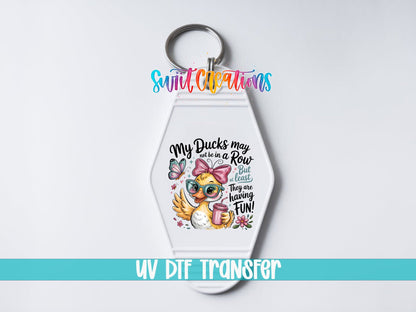 My Ducks May Not Be in a Row UV DTF transfer on a white motel keychain on a white background