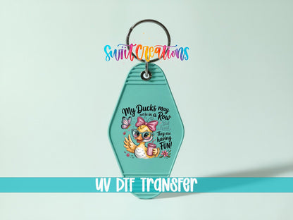 My Ducks May Not Be in a Row UV DTF transfer on a teal motel keychain on a mint background