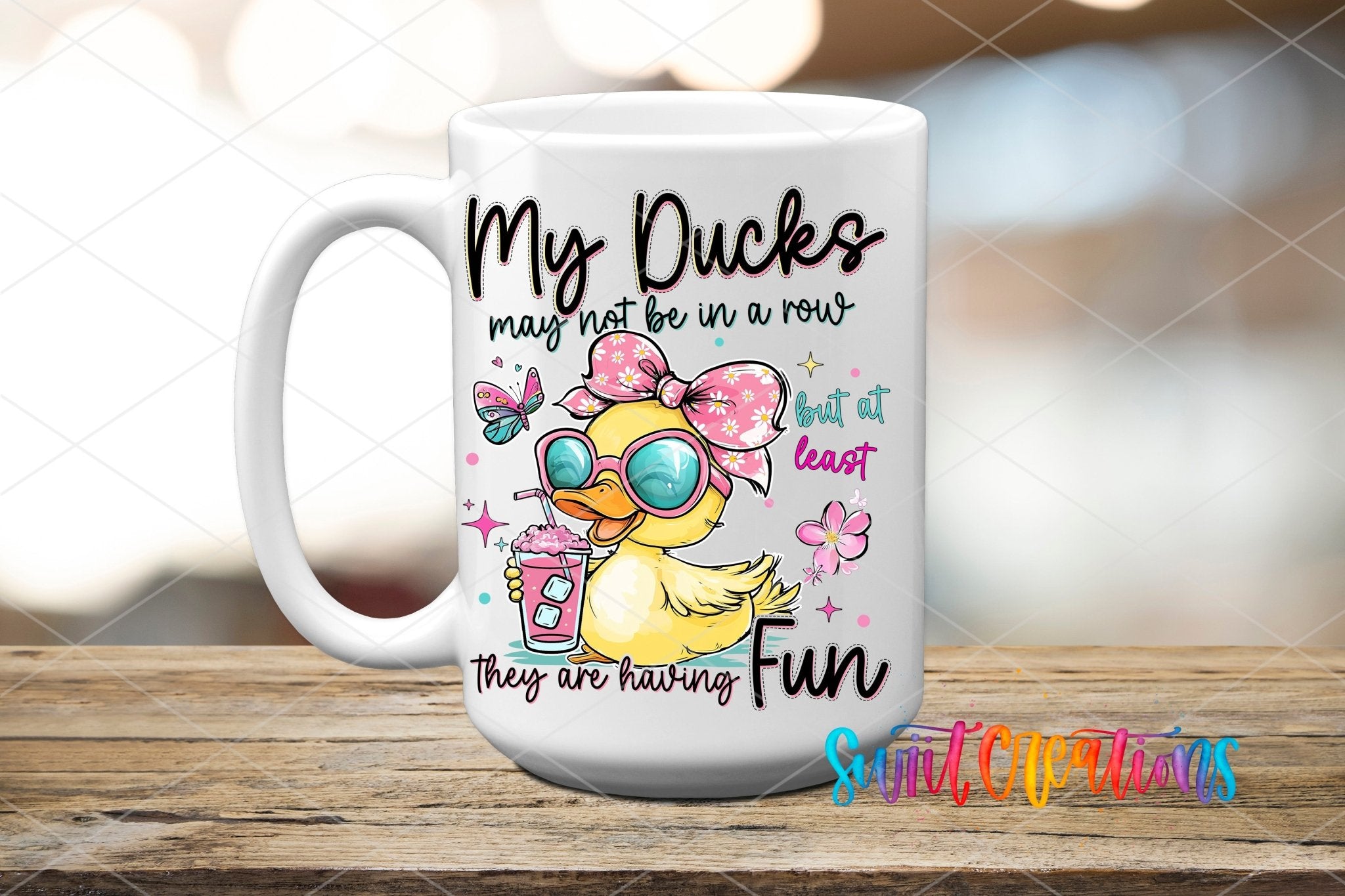 My Ducks May Not Be In A Row UV DTF transfer displayed on a white ceramic mug from Swiit Creations