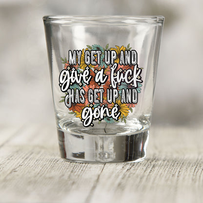 My Get Up and Give a F*ck shot glass UV DTF transfer with orange, teal, and yellow floral background on a clear shot glass