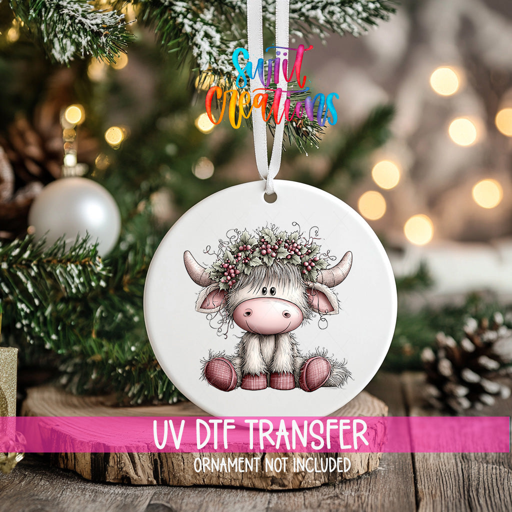 Pink Highland cow holly crown UV DTF transfer on a round ornament mockup