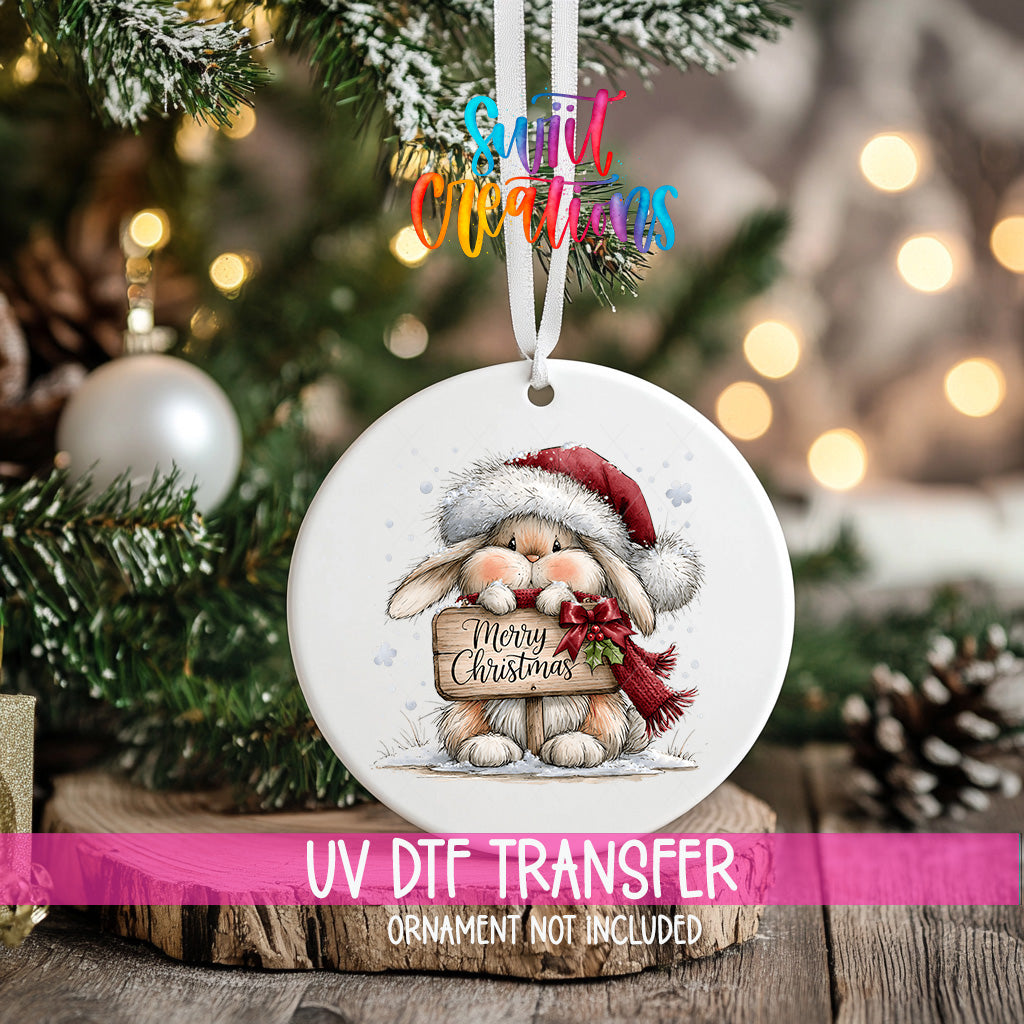 Merry Christmas bunny ornament UV DTF transfer with Santa hat, scarf, holly, and rustic sign, mockup view 2