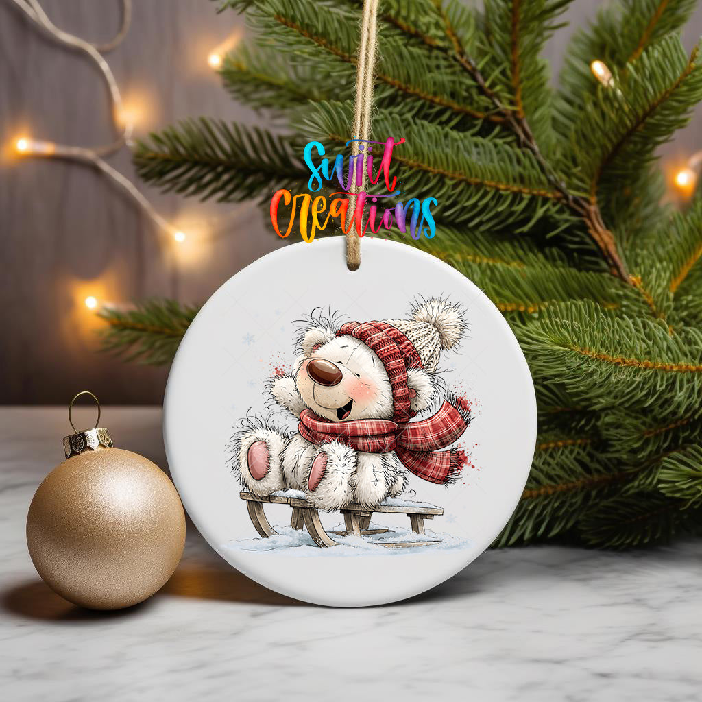 White Christmas bear ornament UV DTF transfer beside decorated tree and wrapped gifts, mockup view 3