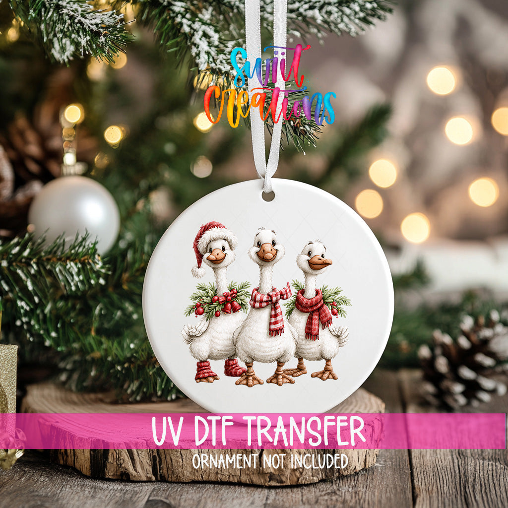 Three Christmas geese ornament UV DTF transfer with red plaid scarves, greenery, and berries, mockup view 2
